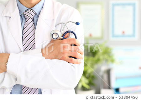 Physician holding stethoscope Physician holding stethoscope 53804450