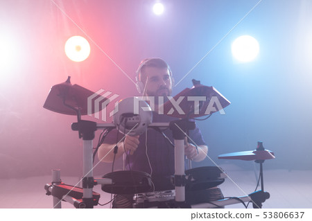 people, hobby and misic concept - musician playing the drums on blue studio background 53806637
