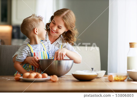 Happy family mother and son bake kneading dough in 53806803