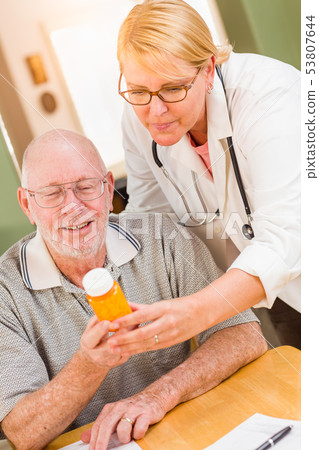 Doctor or Nurse Explaining Prescription Medicine 53807644