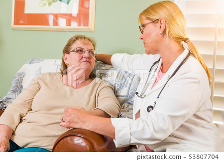 Happy Smiling Doctor or Nurse Talking to Senior 53807704