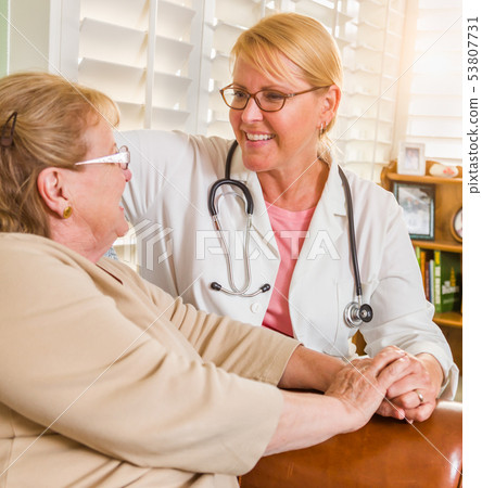Happy Smiling Doctor or Nurse Talking to Senior 53807731