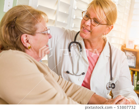 Happy Smiling Doctor or Nurse Talking to Senior 53807732