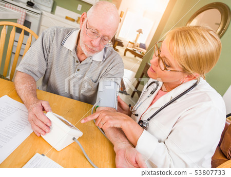 Female Nurse or Doctor Helping Senior Adult Man 53807733