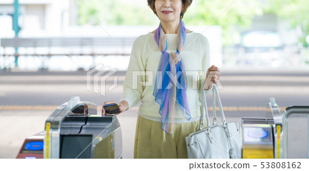 Senior woman station train commuting image photography cooperation: Keio Electric Railway Co., Ltd. Senior woman station train commuting image photography cooperation: Keio Electric Railway Co., Ltd. 53808162
