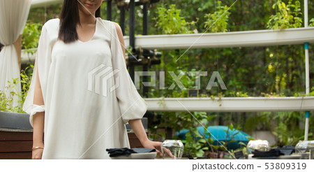 Woman white short dress sit in Herb restaurant 53809319