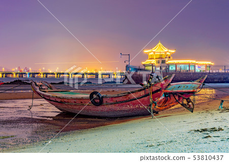 Fishing boat docked at a beach in Xiamen 53810437