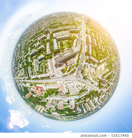 Aerial city view with crossroads and roads, houses, buildings, parks and parking lots. Sunny summer 53813468