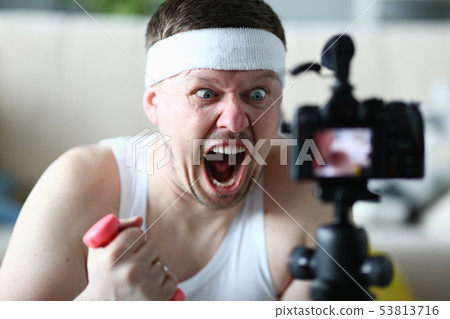 Screaming Man Holding Dumbbell Record on Camera Screaming Man Holding Dumbbell Record on Camera 53813716