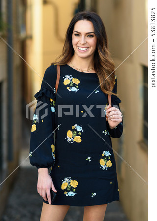 Young woman walking in urban background. Female in Young woman walking in urban background. Female in 53813825