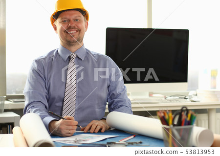 Happy Workman Sketching Building Blueprint at Desk 53813953