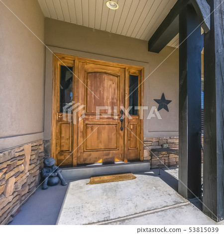 Entrance of home with brown door and sunny porch 53815039