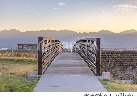 Bridge in Oquirrh Lake with sunset in the horizon 53815195