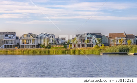 Beautiful cloudy sky over homes along Oquirrh Lake 53815251