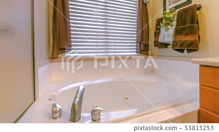 Bathtub inside a sunlit bathroom of a home 53815253