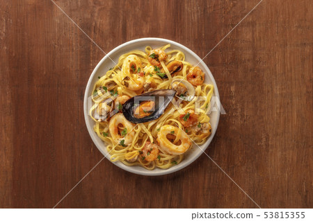 Seafood pasta. A plate of tagliolini with mussels, shrimps, clams and squid rings, shot from the top Seafood pasta. A plate of tagliolini with mussels, shrimps, clams and squid rings, shot from the top 53815355