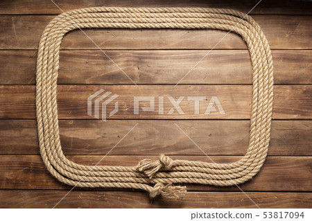 ship rope at wooden board background ship rope at wooden board background 53817094