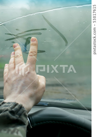 human fingers drawing on a glass car human fingers drawing on a glass car 53817615