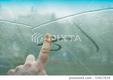 human fingers drawing on a glass car human fingers drawing on a glass car 53817616