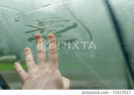 human fingers drawing on a glass car human fingers drawing on a glass car 53817617
