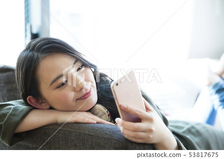 Woman young woman sofa smartphone smart phone lifestyle Woman young woman sofa smartphone smart phone lifestyle 53817675