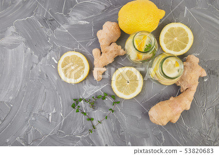 Detox water in bottles with ingredients, ginger, lemon, mint Detox water in bottles with ingredients, ginger, lemon, mint 53820683