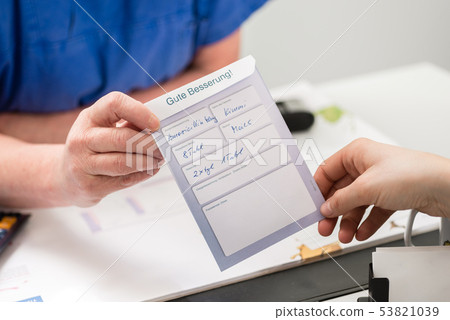 Female veterinarian showing card to pet owner Female veterinarian showing card to pet owner 53821039