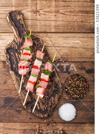 Raw pork kebab with paprika on vintage board Raw pork kebab with paprika on vintage board 53821399