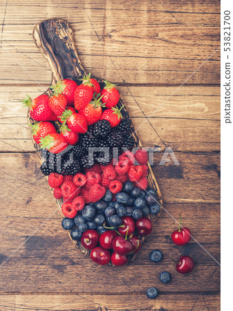 Fresh organic summer berries mix on vintage wooden Fresh organic summer berries mix on vintage wooden 53821700