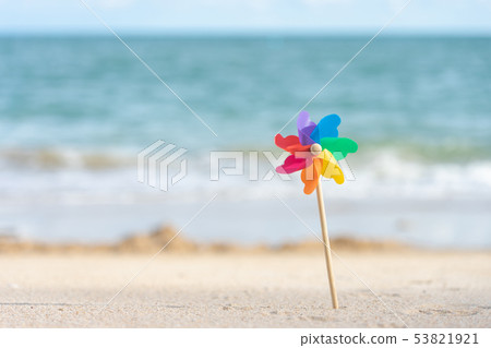 Colorful windmill paper embroidered on the beach Colorful windmill paper embroidered on the beach 53821921