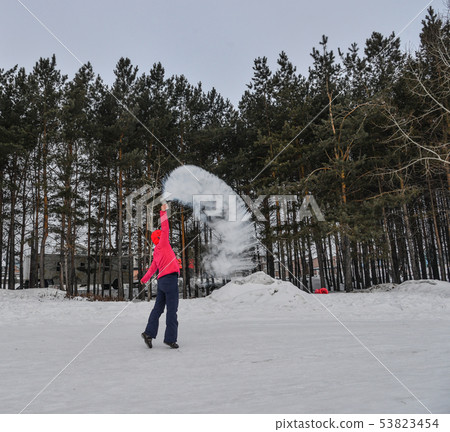 A tourist throwing hot water at winter park A tourist throwing hot water at winter park 53823454