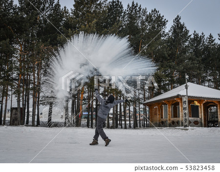 A tourist throwing hot water at winter park A tourist throwing hot water at winter park 53823458