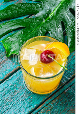 Orange drink with cherry 53823717