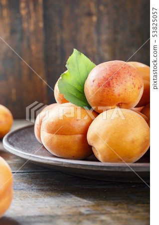 Delicious ripe apricots in a plate on the table 53825057