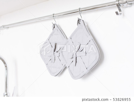Kitchen potholder on a white brick wall background Kitchen potholder on a white brick wall background 53826955