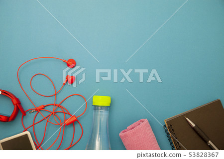 Close up of water bottle,watch and red earphones Close up of water bottle,watch and red earphones 53828367