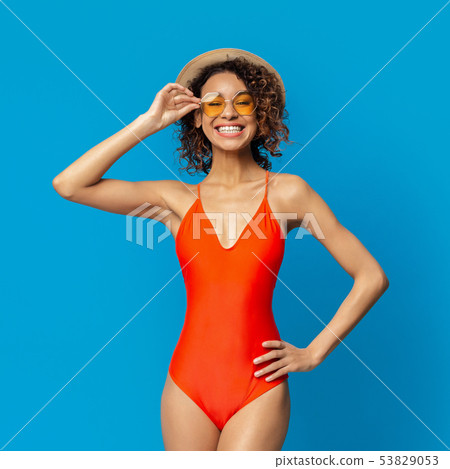 Cute african girl in red swimsuit enjoying summer time 53829053