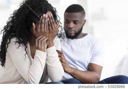 Loving man soothing crying woman, apologizing after quarrel 53829066