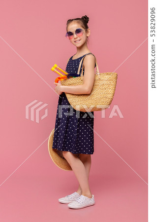Little girl going to swim with diving mask in wicker bag 53829096