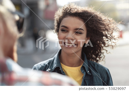 Merry young woman is enjoying time with guy outdoor Merry young woman is enjoying time with guy outdoor 53829097