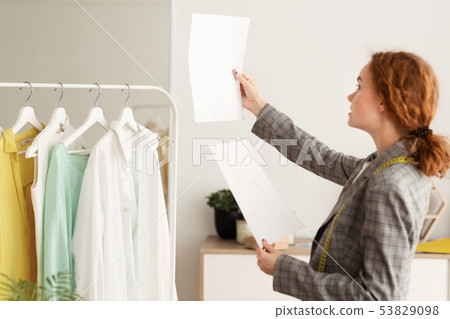 Young Designer Checking And Comparing Sketches On Papers Young Designer Checking And Comparing Sketches On Papers 53829098