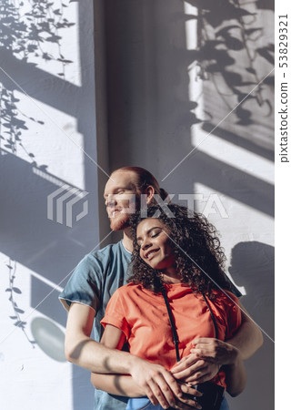 Happy guy is embracing beloved girl indoors 53829321