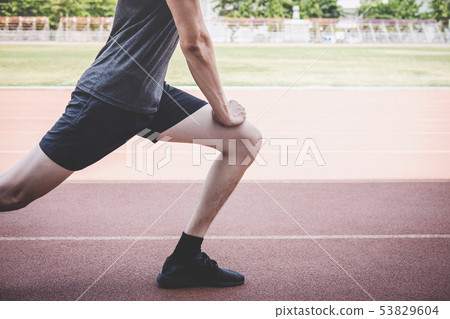 Young fitness athlete man running on road track, 53829604