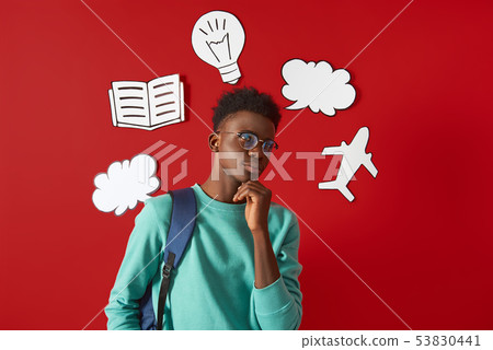 Pensive Afro guy is standing with backpack Pensive Afro guy is standing with backpack 53830441