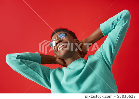 Happy man in glasses is making dance moves in studio Happy man in glasses is making dance moves in studio 53830622