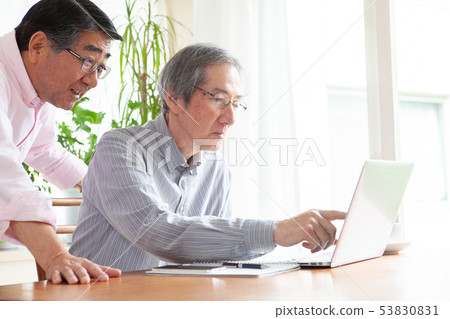 Senior man doing home work Senior man doing home work 53830831