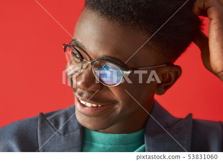 Positive young afro guy is looking with smile Positive young afro guy is looking with smile 53831060