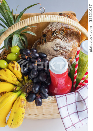 Basket filled food fruit striped plaid Picnic 53831087