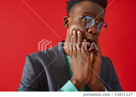 Afro American guy is covering face with hands Afro American guy is covering face with hands 53831127