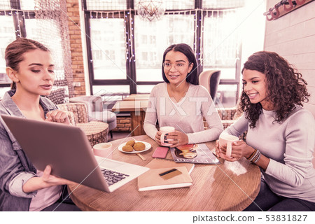 Young team of promising fashion designers working on new collection in workspace 53831827